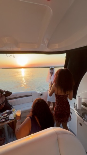 Guests enjoying the sunset view from the yacht