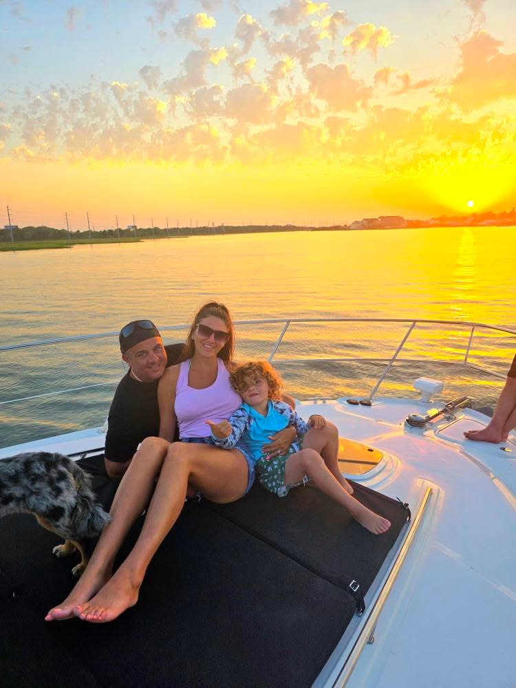 Family relaxing on sunset cruise