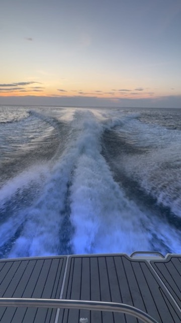 Yacht wake at sunset